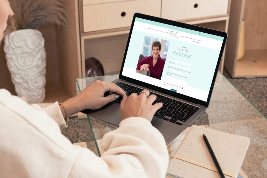 Woman typing information into a client inquiry form.